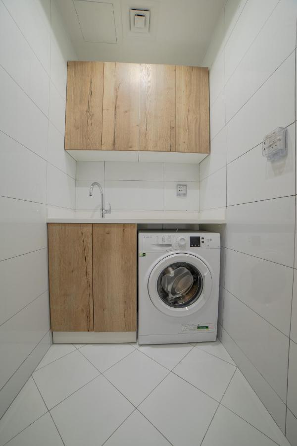 Platinum Coast Hotel Apartments Fujairah Exterior photo A washing machine in a laundry room